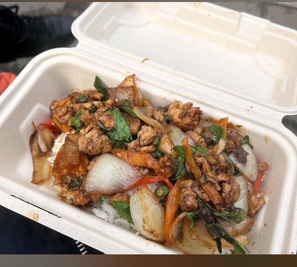 Cashew nut chicken stir-fry with peppers and onion over rice