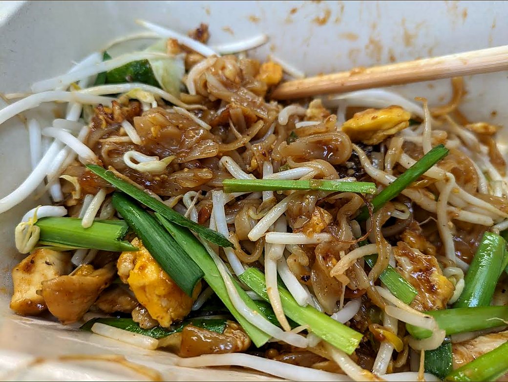 A close-up of Super Thai's wet-style Pad Thai with bean sprouts, egg and green onion