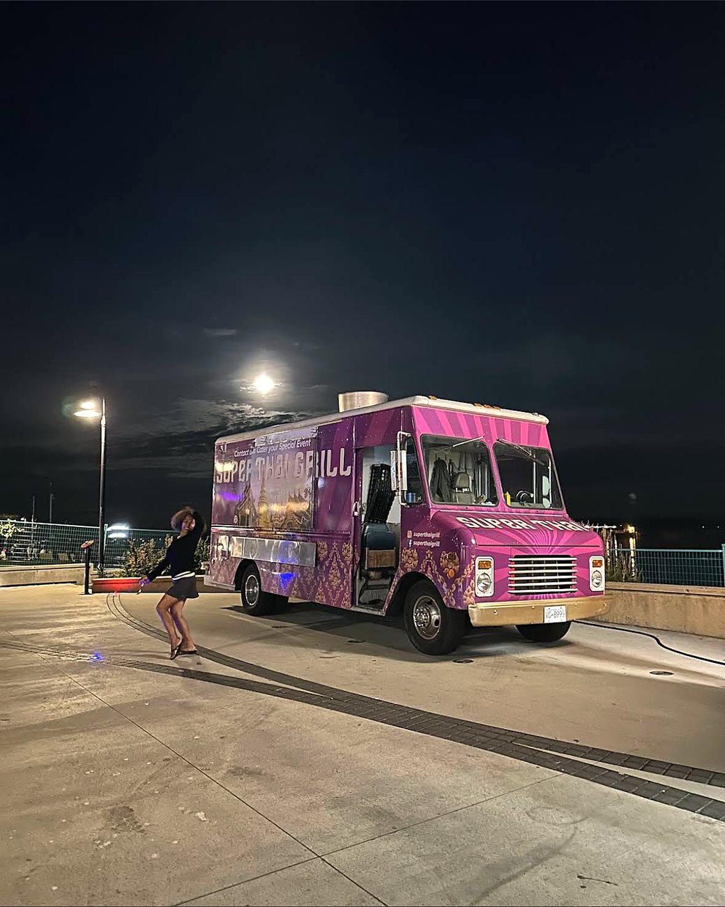 The Super Thai truck lit up at night